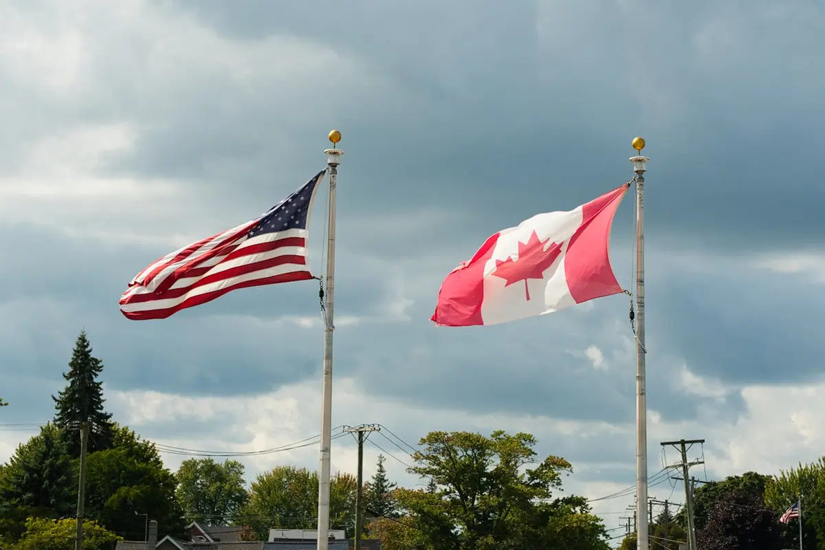The Canadian and American flags wave proudly side-by-side