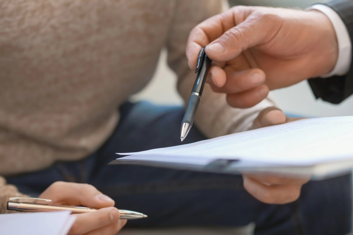Attorney showing client document in office, closeup