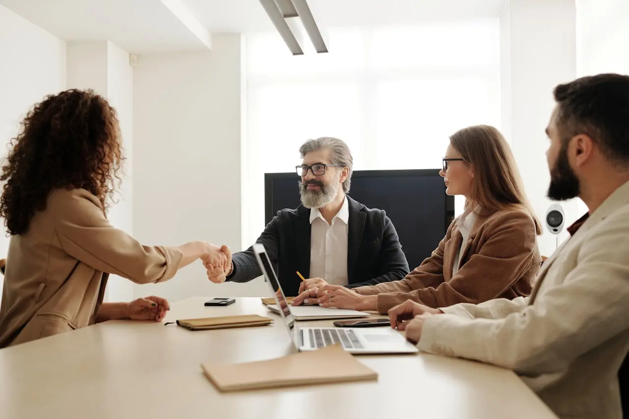 Law firm staff welcome a new Legal Content Marketing hire with a handshake.
