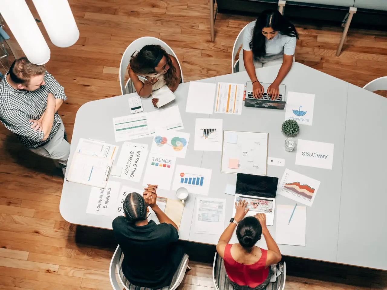 Legal marketers sit at a conference table reviewing content and SEO strategies.