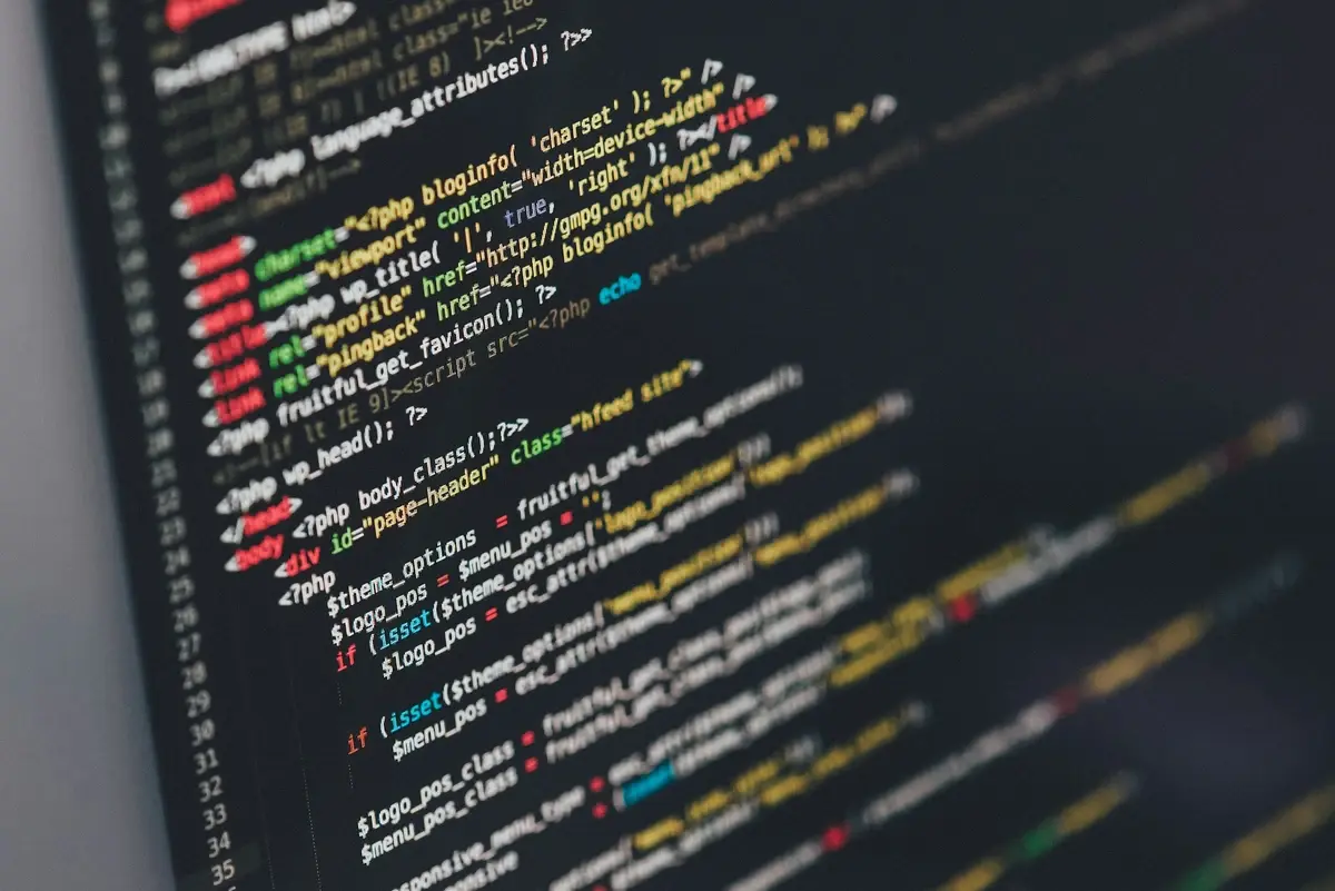 A computer screen displays colorful PHP and HTML website code