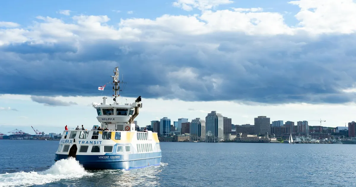 A Halifax Transit ferry crossing the harbour, with the Halifax skyline behind it