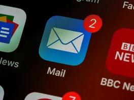 Close-up of a mobile phone screen with an email icon indicating unread messages