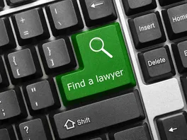 Concept image: close-up of a mechanical computer keyword with the large 'Enter' key replaced with a 'Find A Lawyer' key.