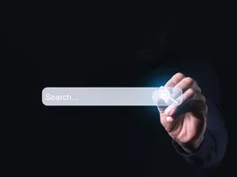Internet search page being clicked on a computer's touch screen by a businessman while searching the internet
