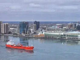 Windsor, Ontario waterfront with a red cargo ship in the water